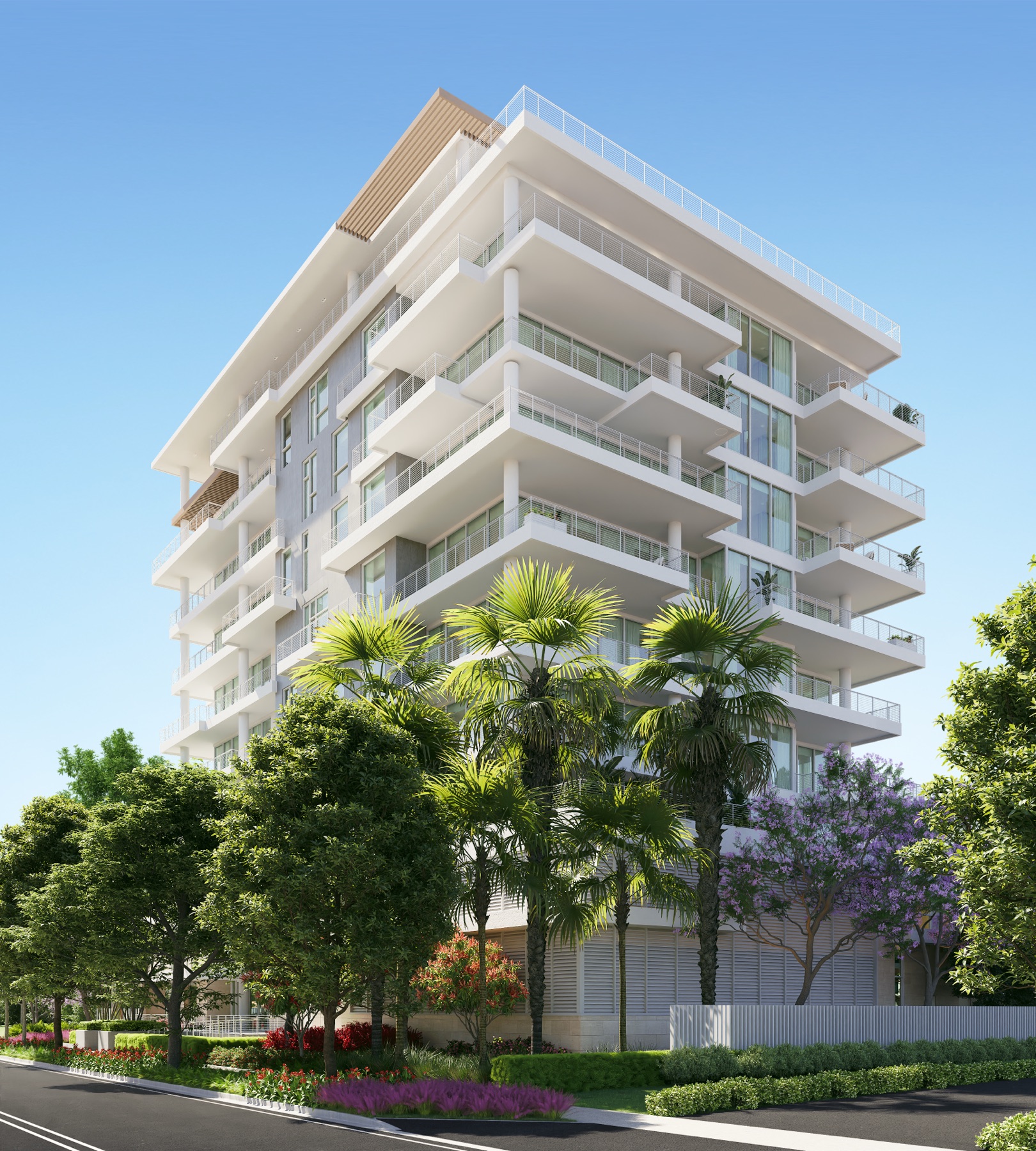 Street view of The Terraces Fort Lauderdale Beach — a white, ten-story boutique condominium with cantilevered private terraces at 527 Orton Avenue, framed by palms and flowering jacaranda in the North Beach Village enclave.