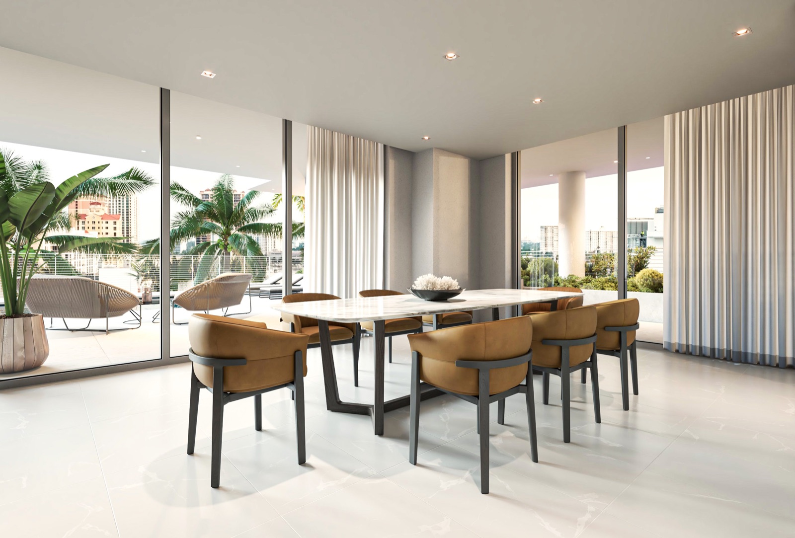 The residents' club lounge at The Terraces Fort Lauderdale Beach — a refined dining and entertaining room with a marble table, leather seating, and floor-to-ceiling glass opening to the terrace and Intracoastal views.